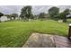 Large backyard features mature trees, playset, and plenty of space for activities at 5760 Tim Tam Ct, Indianapolis, IN 46237