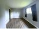Bedroom featuring neutral colored walls, wood flooring, and window at 5760 Tim Tam Ct, Indianapolis, IN 46237