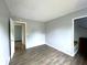 Bedroom featuring neutral colored walls, wood flooring, and two entryways at 5760 Tim Tam Ct, Indianapolis, IN 46237
