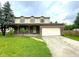 Charming two-story home featuring a covered front porch, attached garage, and well-maintained lawn at 5760 Tim Tam Ct, Indianapolis, IN 46237