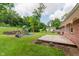 Spacious backyard with a wooden deck and a playground, great for outdoor activities at 6030 Riverview Dr, Indianapolis, IN 46208