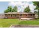 The backyard features a brick house, lawn, and wood deck perfect for outdoor relaxation at 6030 Riverview Dr, Indianapolis, IN 46208