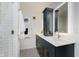 Bathroom features a stylish vanity with a sleek white countertop and a modern, illuminated mirror at 6030 Riverview Dr, Indianapolis, IN 46208