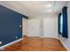 This bedroom features hardwood floors, neutral walls, and ample closet space at 6030 Riverview Dr, Indianapolis, IN 46208