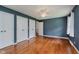 Neutral bedroom features hardwood floors and multiple closets for storage at 6030 Riverview Dr, Indianapolis, IN 46208