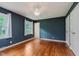 Spacious bedroom features hardwood floors, and natural light from windows at 6030 Riverview Dr, Indianapolis, IN 46208