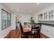 Traditional dining room features hardwood floors, table with seating, and built in cabinets at 6030 Riverview Dr, Indianapolis, IN 46208