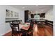 Dining room adjacent to kitchen with hardwood flooring and modern lighting at 6030 Riverview Dr, Indianapolis, IN 46208