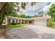 Charming single story brick home featuring a two-car garage and mature landscaping at 6030 Riverview Dr, Indianapolis, IN 46208