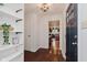 Bright entry way with a closet, access to kitchen, and a stylish blue door at 6030 Riverview Dr, Indianapolis, IN 46208