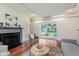 Bright living room with hardwood floors, a fireplace, and sliding glass doors at 6030 Riverview Dr, Indianapolis, IN 46208