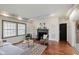 Comfortable living room features hardwood floors, and a traditional fireplace at 6030 Riverview Dr, Indianapolis, IN 46208