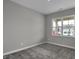 Carpeted bedroom featuring gray walls, white trim and baseboards, and a bright window at 611 Bridgeman Rd, Avon, IN 46123