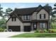 Charming two-story home with brick and siding, black trim, and an attached two-car garage at 6269 Stone Side Dr, Plainfield, IN 46168