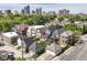 Aerial view showcases neighborhood with well-maintained homes, greenery, and a city skyline at 635 E 10Th St, Indianapolis, IN 46202