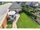 Aerial view of landscaped backyard with patio seating and a well-maintained lawn at 635 E 10Th St, Indianapolis, IN 46202