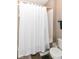 Cozy bathroom featuring a shower with white tile surround and a shower curtain at 635 E 10Th St, Indianapolis, IN 46202