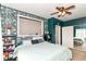 Inviting bedroom featuring stylish wallpaper, natural lighting, and ample closet space at 635 E 10Th St, Indianapolis, IN 46202