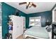 Well-lit bedroom with a ceiling fan, closet storage, and comfortable furnishings at 635 E 10Th St, Indianapolis, IN 46202