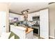Modern kitchen with white cabinets, stainless steel appliances, and stylish backsplash at 635 E 10Th St, Indianapolis, IN 46202