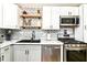 Modern kitchen with stainless appliances, chevron backsplash, marble countertops, and sleek cabinetry at 635 E 10Th St, Indianapolis, IN 46202