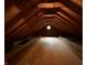 Spacious attic with exposed rafters and small window at 6609 N Tuxedo Ln, Indianapolis, IN 46220