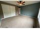 Cozy bedroom with double-door closet and neutral carpet at 6609 N Tuxedo Ln, Indianapolis, IN 46220