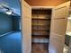 Walk-in closet with shelving in Primary suite, plus view to bedroom and bathroom at 6609 N Tuxedo Ln, Indianapolis, IN 46220