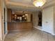 Open dining area with breakfast bar, custom built-ins, tiled floors, and view to kitchen at 6609 N Tuxedo Ln, Indianapolis, IN 46220