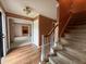 Spacious entryway with staircase and view to living room featuring fireplace at 6609 N Tuxedo Ln, Indianapolis, IN 46220