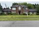 Charming brick two-story home features a well-manicured lawn and beautiful landscaping at 6609 N Tuxedo Ln, Indianapolis, IN 46220