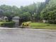 View of home's front yard, featuring mature trees and a driveway leading to a garage at 6609 N Tuxedo Ln, Indianapolis, IN 46220