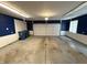 Spacious garage with painted walls, white doors, and concrete flooring at 6609 N Tuxedo Ln, Indianapolis, IN 46220