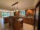 Gourmet kitchen featuring custom wood cabinets, tiled floors, and large island at 6609 N Tuxedo Ln, Indianapolis, IN 46220