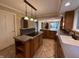 Gourmet kitchen featuring custom cabinetry, tiled floors, and large island at 6609 N Tuxedo Ln, Indianapolis, IN 46220