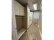 A spacious laundry room includes white cabinets, tan countertops, and tile flooring at 6609 N Tuxedo Ln, Indianapolis, IN 46220