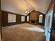 Living room with a brick fireplace, large windows, and neutral carpet at 6609 N Tuxedo Ln, Indianapolis, IN 46220