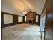 Spacious living room boasts a brick fireplace, high ceilings, and neutral carpet at 6609 N Tuxedo Ln, Indianapolis, IN 46220