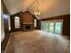 Living room with brick fireplace, chandelier, and sliding glass doors to the outdoors at 6609 N Tuxedo Ln, Indianapolis, IN 46220