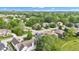 Charming aerial shot of a tree-filled neighborhood with various architectural home styles, green lawns, and a hot air balloon at 6610 Royal Oakland Dr, Indianapolis, IN 46236