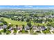 Expansive aerial view of golf course community with lush greenery and well-maintained homes under a blue sky at 6610 Royal Oakland Dr, Indianapolis, IN 46236