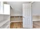 Bright attic storage area with hardwood floors and built-in shelving at 6610 Royal Oakland Dr, Indianapolis, IN 46236