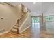 Finished basement has hardwood floors, carpeted stairs, and large windows at 6610 Royal Oakland Dr, Indianapolis, IN 46236