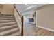 Finished basement features carpeted stairs and hardwood floors at 6610 Royal Oakland Dr, Indianapolis, IN 46236