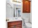 Bathroom features a wood vanity, mirror, and fixtures, with a view of a bedroom at 6610 Royal Oakland Dr, Indianapolis, IN 46236