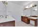 Bathroom with double vanities, large mirrors, and neutral tile flooring at 6610 Royal Oakland Dr, Indianapolis, IN 46236