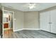 Bedroom showcasing wood-look floors, a ceiling fan, and a peek into the bathroom at 6610 Royal Oakland Dr, Indianapolis, IN 46236