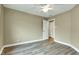 Bedroom featuring wood-look floors and a ceiling fan with an open door at 6610 Royal Oakland Dr, Indianapolis, IN 46236