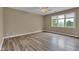 Bedroom featuring light brown walls, ceiling fan, and laminate flooring at 6610 Royal Oakland Dr, Indianapolis, IN 46236