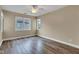 Bedroom features light brown walls, ceiling fan, laminate flooring and multiple windows at 6610 Royal Oakland Dr, Indianapolis, IN 46236